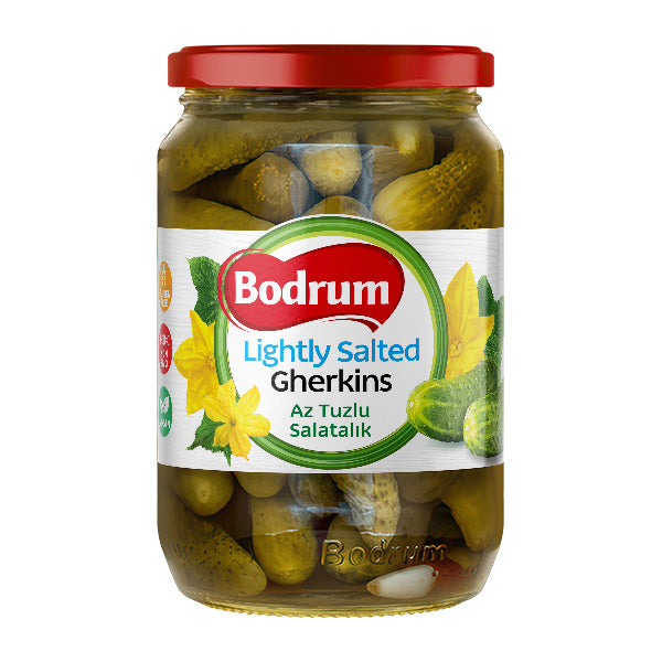 Jar of Bodrum lightly salted gherkins with a red lid on a white background
