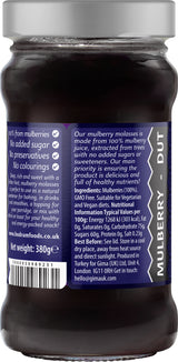 Jar of mulberry jam with a label on a white background