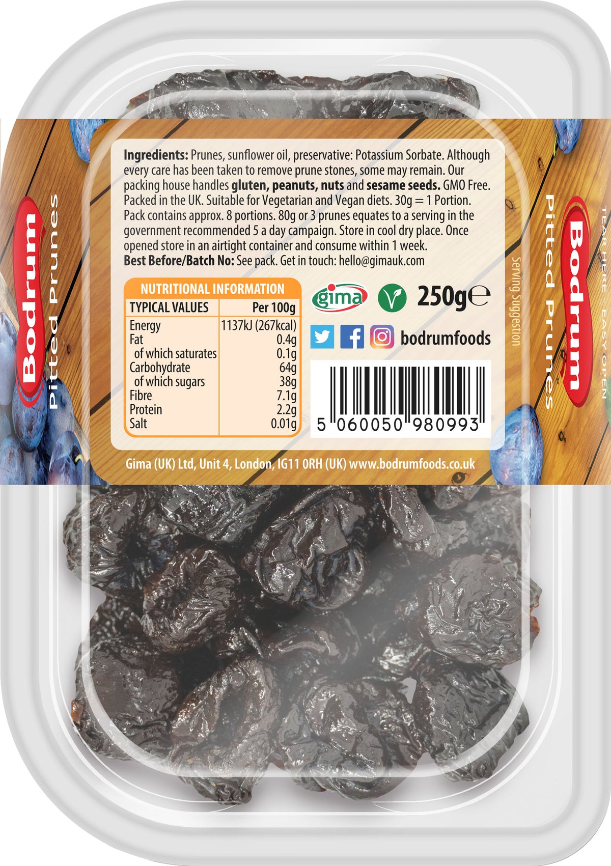 Packaged prunes with a label on a wooden surface