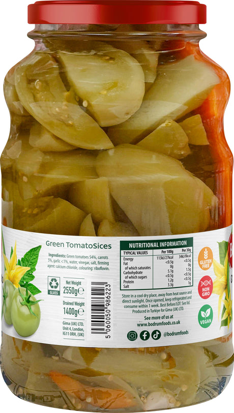 Jar of pickled green tomato slices with a red lid on a white background