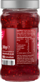 Jar of red jelly with a label showing nutritional information and branding.
