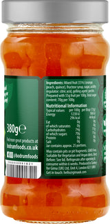 Jar of orange food with a green label showing ingredients and nutritional information.