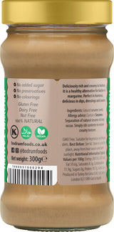 Jar of peanut butter with a gold lid and label detailing nutritional information and ingredients.