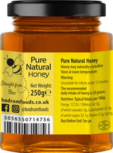 Jar of pure natural honey with label displaying product details and branding.